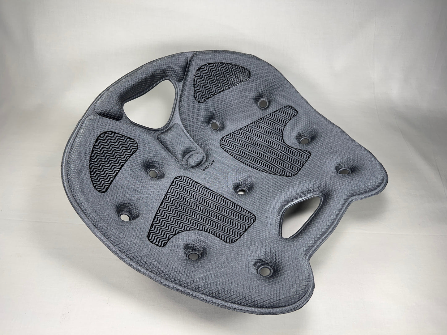 Top view of a gray BackJoy posture corrector seat with traction grips to maintain aligned, pain-free sitting.
